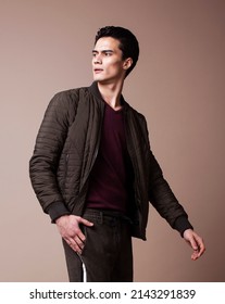 Young Pretty Asian Man Posing In Fashion Style On Light Brown Background, Lifestyle People Concept