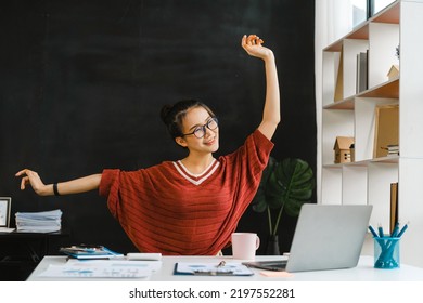 Young Pretty Asian Nerd Woman Stretch Oneself While Sitting At Desk, Work At Home Concept.