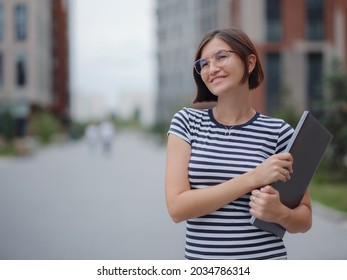 Young Pretty Asian Woman Walking With Laptop In Modern City Street On Remote IT Work, Summer Style Casual Smiling