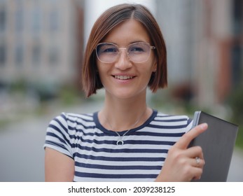 Young Pretty Asian Woman Walking With Laptop In Modern City Street On Remote IT Work, Summer Style Casual Smiling