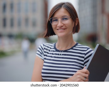 Young Pretty Asian Woman Walking With Laptop In Modern City Street On Remote IT Work, Summer Style Casual Smiling