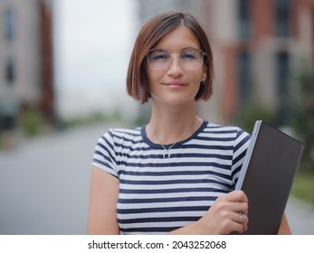 Young Pretty Asian Woman Walking With Laptop In Modern City Street On Remote IT Work, Summer Style Casual Smiling