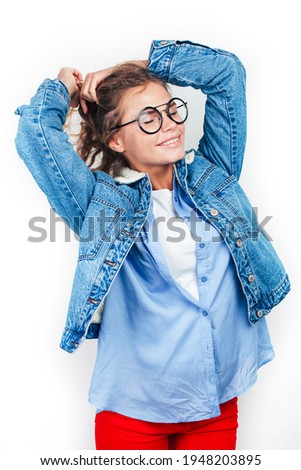 young pretty blond teenage hipster girl in glasses posing emotional happy smiling, gesturing isolated on white background, lifestyle poeple concept