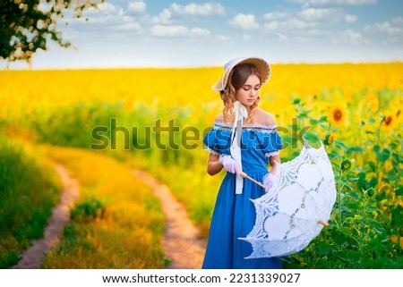 Young pretty blonde curly girl in straw hat, lace umbrella and vintage dress posing in field of sunflowers.Beautiful elegant lady in bonnet on colorful warm art work. 
