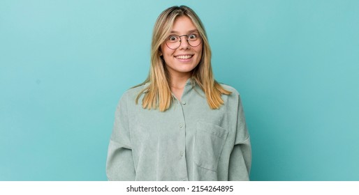 Young Pretty Blonde Woman Looking Happy And Goofy With A Broad, Fun, Loony Smile And Eyes Wide Open