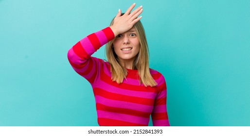 Young Pretty Blonde Woman Raising Palm To Forehead Thinking Oops, After Making A Stupid Mistake Or Remembering, Feeling Dumb