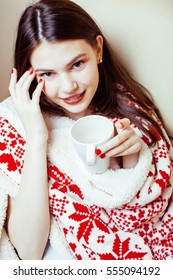 young pretty brunette girl in Christmas ornament blanket getting warm on cold winter, freshness beauty concept, lifestyle people