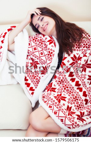 young pretty brunette girl in Christmas ornament blanket getting warm on cold winter, freshness beauty concept