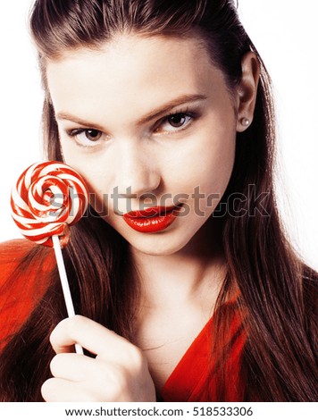 young pretty brunette girl with red candy posing on white backgr