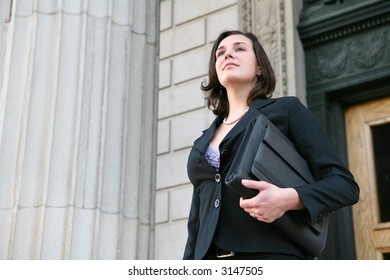 A Young Pretty Business Woman Leaving The Office Building