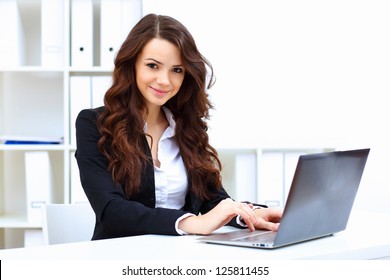 Young pretty business woman with notebook in the office - Powered by Shutterstock