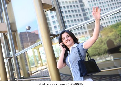 A Young Pretty Business Woman Waving Goodbye At Office Building