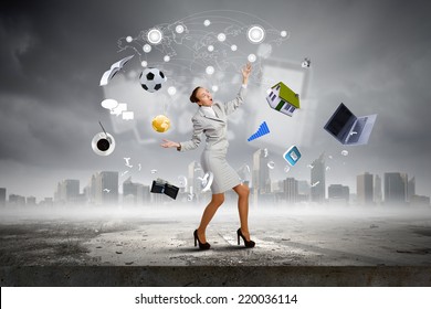 Young pretty businesswoman juggling with white balls