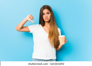 Young Pretty Caucasian Woman Holding A Takeaway Coffee Showing A Dislike Gesture, Thumbs Down. Disagreement Concept.