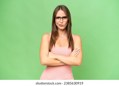 Young pretty caucasian woman over isolated background with unhappy expression - Shutterstock ID 2385630919