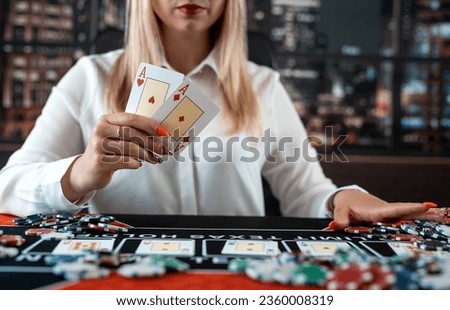 Young pretty caucasian woman showing two aces  for win at casino in poker game. Gambling concept
