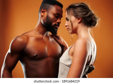 Young pretty couple diverse races together posing sensitive on brown background, lifestyle people concept