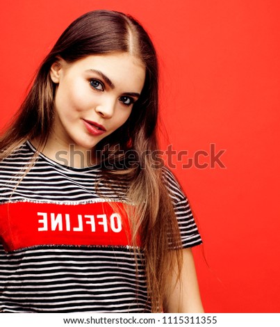 young pretty emitonal posing teenage girl on bright red backgrou