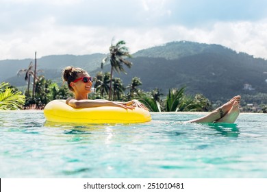 Young Pretty Fashion Woman Body Posing In Summer In Pool With Clear Water Lying Inner Tube And Having Fun