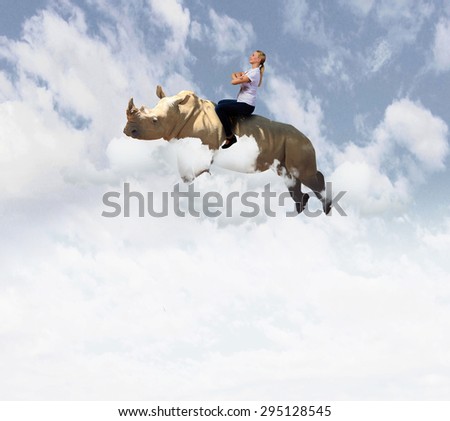 Young pretty fearless woman riding huge flying