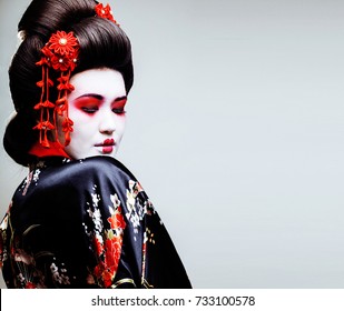 Young Pretty Geisha In Kimono With Sakura And Red Decoration Des