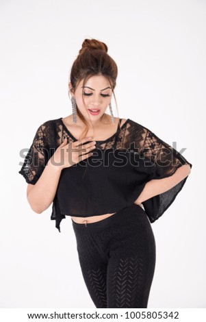 Young pretty girl in black dress on white background