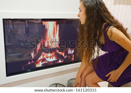 Similar – Mother hugging her baby in front of fireplace