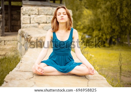 Similar – Young woman doing yoga in nature