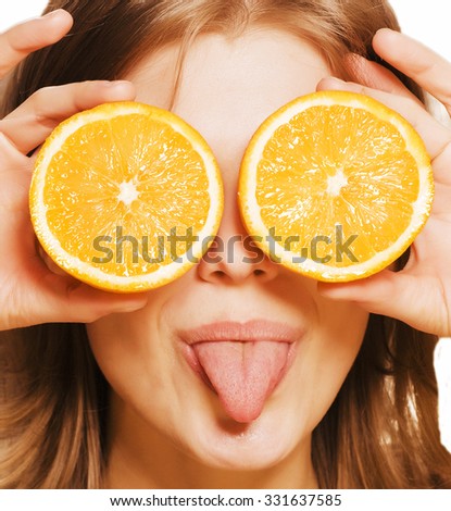 young pretty girl with orange close up teasing tongue