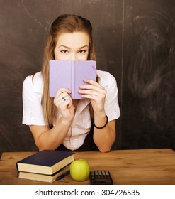 Young Pretty Girl Student In Classroom At Blackboard Doing Homework