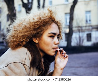 young pretty girl teenage outside smoking cigarette close up, lo