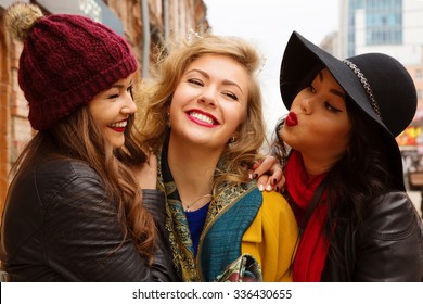 Young pretty  girls best friends smiling and having  fun, walking at the city. Shopping.  Wearing stylish outerwear. Bright make up. Positive emotions. Outdoors lifestyle fashion close up portrait 
