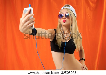 young pretty hipster woman listening music and dancing. 