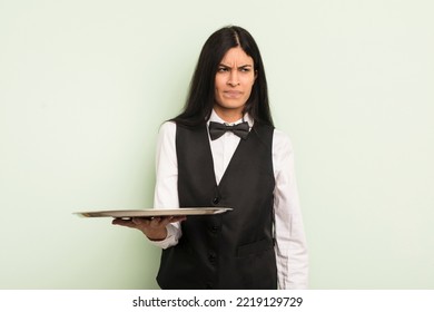 Young Pretty Hispanic Woman Feeling Sad, Upset Or Angry And Looking To The Side. Waiter With Tray Concept