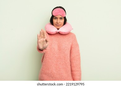 Young Pretty Hispanic Woman Looking Serious Showing Open Palm Making Stop Gesture. Plane Passenger Concept