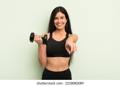 Young Pretty Hispanic Woman Pointing At Camera Choosing You. Fitness Concept