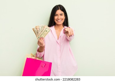 Young Pretty Hispanic Woman Pointing At Camera Choosing You. Shopping Bags Concept