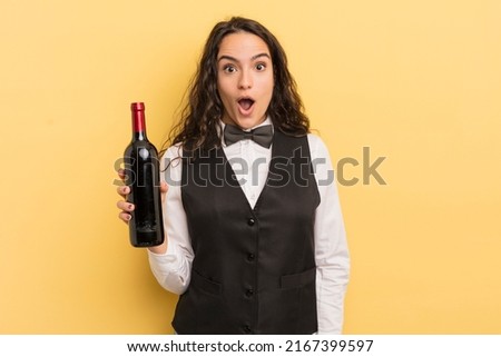 young pretty hispanic woman waiter with a bottle of wine