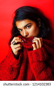 young pretty indian girl in red sweater posing emotional, fashio