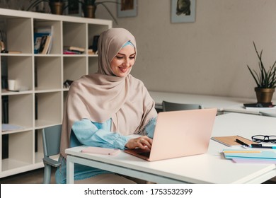 Young Pretty Modern Muslim Woman In Hijab Working On Laptop In Office Room, Education Online, Remote Work Freelancer, Typing Thinking Concentrated