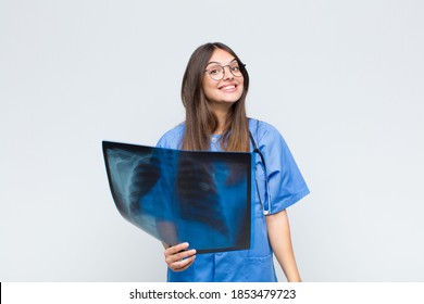 Young Pretty Nurse Looking Happy And Pleasantly Surprised, Excited With A Fascinated And Shocked Expression