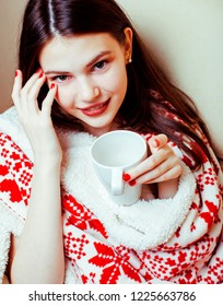 young pretty real woman in sweater and winter Christmas blanket,