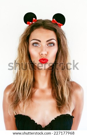 Young pretty seductive woman send you kiss, making funny faces have positive mood and emotions, wearing mouse playful ears. have bright lips and perfect glowing skin, white background, not isolated.