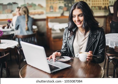 Young Pretty Spanish Woman In Cafe In City Centre With Tablet Laptop