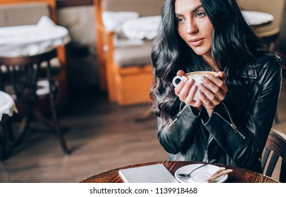 Young Pretty Spanish Woman In Cafe In City Centre With Tablet Laptop