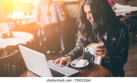 Young Pretty Spanish Woman In Cafe In City Centre With Tablet Laptop