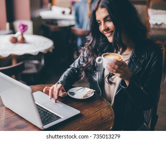 Young Pretty Spanish Woman In Cafe In City Centre With Tablet Laptop