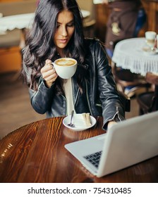 Young Pretty Spanish Woman In Cafe In City Centre With Tablet Laptop