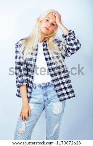 young pretty stylish blond hipster girl posing emotional isolate