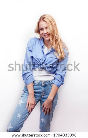 young pretty stylish blond hipster girl posing emotional isolated on white background happy smiling cool smile, lifestyle people concept